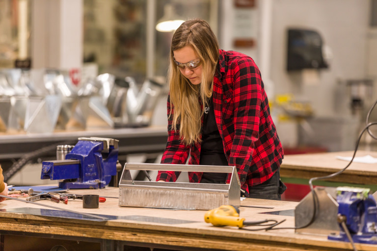 Women in Trades Training student working on sheet metal project