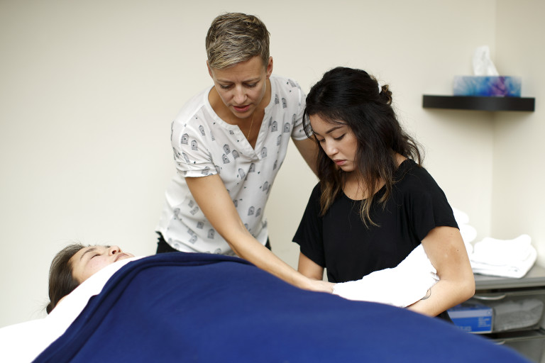 Emah Christiansen guiding for technique in Massage Lab